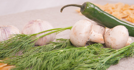 Mushrooms, herbs and chili peppers on a linen backgroundの写真素材