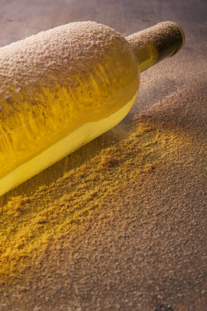 Vintage wine bottle, covered with dust on the wooden tableの写真素材