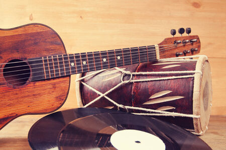Vintage acoustic guitar, drum and vinyl record on a wooden backgroundの写真素材