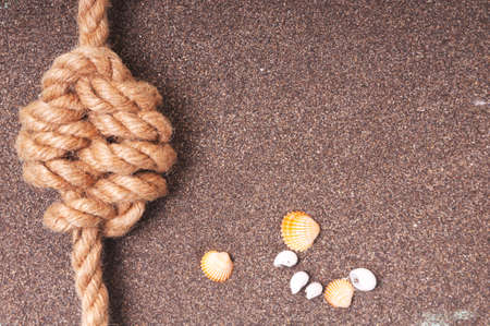 Marine rope with a knot on the sandの写真素材