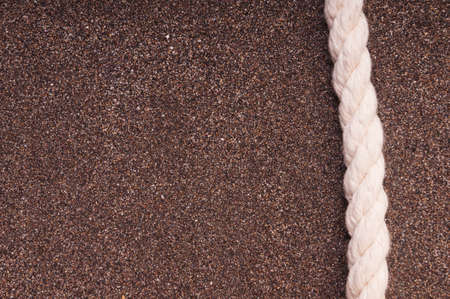 Marine rope with a knot on the sandの写真素材