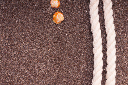 Marine rope with a knot on the sandの写真素材