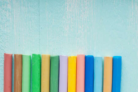 Pastel on turquoise wooden surfaceの写真素材