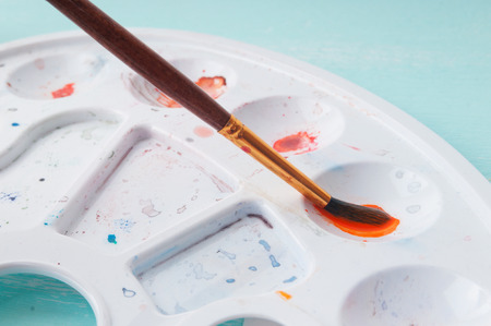 A man takes a brush watercolor paint before paintingの写真素材