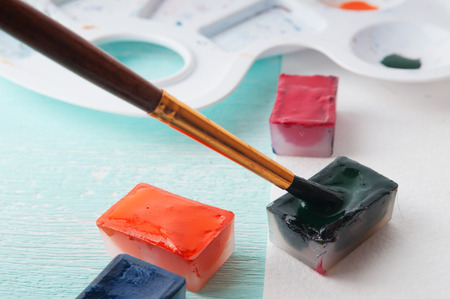 A man takes a brush watercolor paint before paintingの写真素材