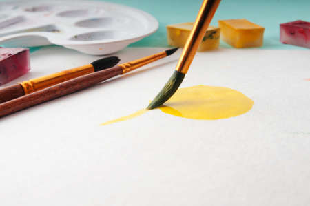 The process of applying a watercolor painting on paperの写真素材