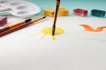 The process of applying a watercolor painting on paperの写真素材