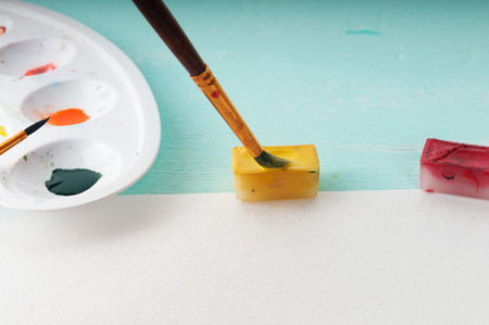 A man takes a brush watercolor paint before paintingの写真素材