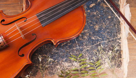 Violin, bow and old book tableの写真素材