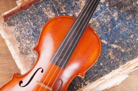 Violin, bow and old book tableの写真素材