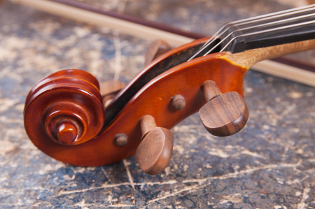 Violin, bow and old book tableの写真素材