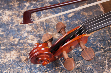 Violin, bow and old book tableの写真素材