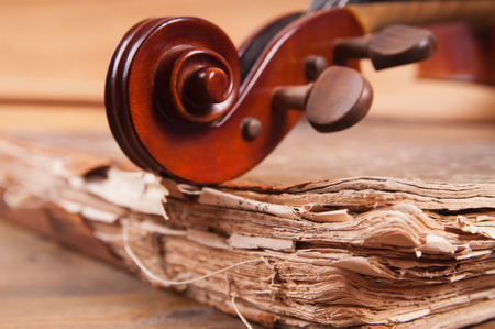 Violin, bow and old book tableの写真素材