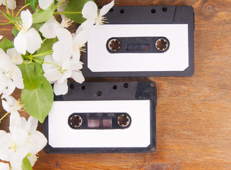 Audio cassette and spring flowers on a wooden tableの写真素材