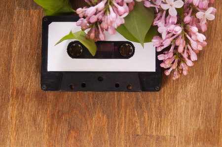 Audio cassette and spring flowers on a wooden tableの写真素材