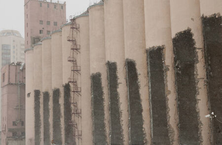 Ruined elevator on a cloudy day with snowfall