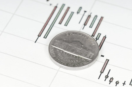 Dollar coin on a graph. Financial up and down trend.の写真素材
