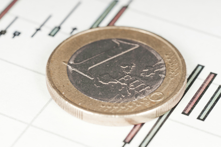 Euro coin on a graph. Financial up and down trend.の写真素材