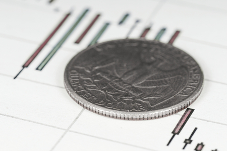 Dollar coin on a graph. Financial up and down trend.の写真素材