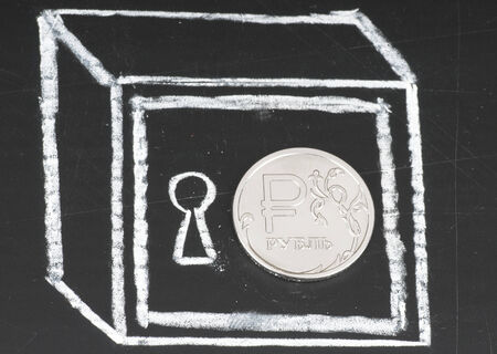 Russian ruble coin and drawn on a chalkboard safe. Save money concept.の写真素材