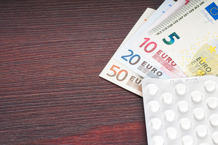 drugs, pills and money on the tableの写真素材