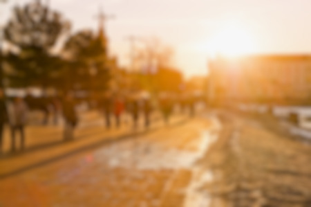 people with long shadows, street on sunset, blur backgroundの写真素材