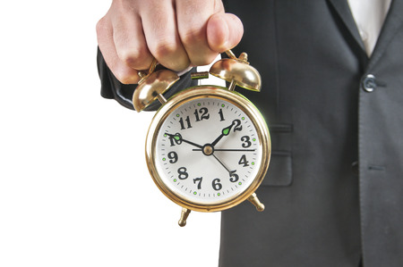Businessman holding alarm clockの写真素材