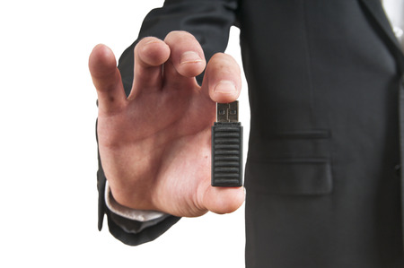 Flash drive in hand isolated on white backgroundの写真素材