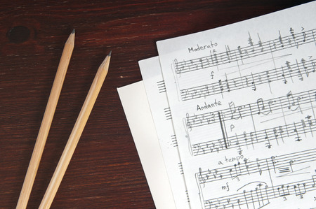 Music notes and two pencils on tableの写真素材