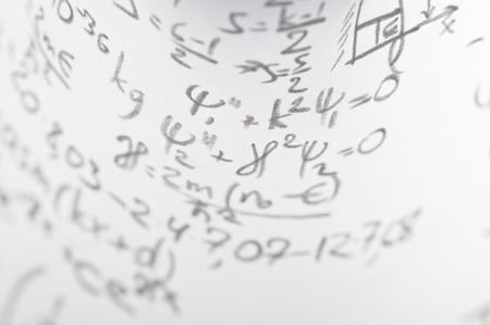 sheet of paper filled with calculations of nuclear and quantum physics as a background