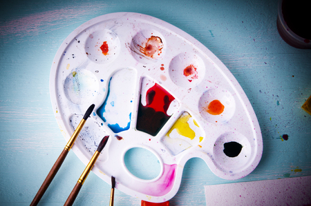 art palette with paint and brushes, close upの写真素材