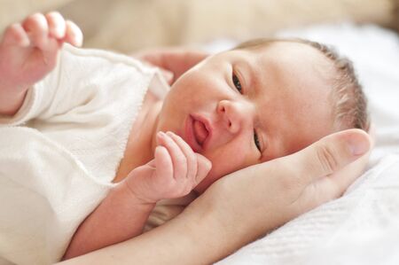 Two weeks old baby on the arm