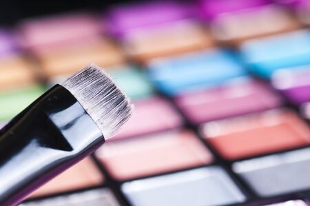 make-up brushes on colorful eye shadows paletteの写真素材