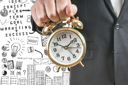 Businessman holding alarm clockの写真素材