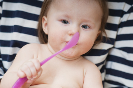 little girl playing with a spoon