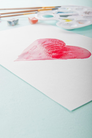 Red heart painted with watercolor on paper. Background on Valentine's Dayの写真素材