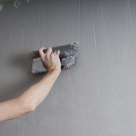 
Hands Plasterer at work. Application of the plaster on the wall. textured plasterの写真素材