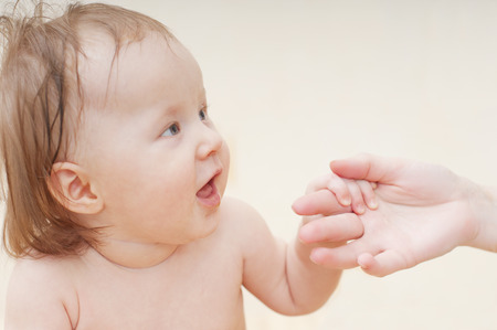 Little girl holding her mother's handの写真素材