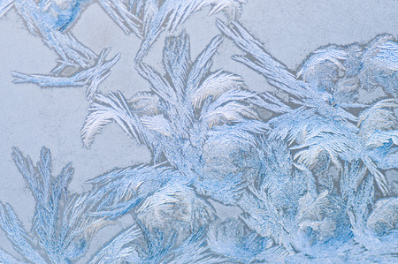 Frosty winter background photo of ice buildup on a window