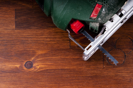 Electric jigsaw on the table
