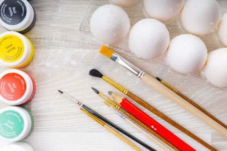 Eggs, paint and paint brush on the table. Preparation for Easterの写真素材