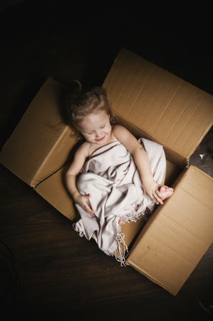 Little girl sitting in a boxの写真素材