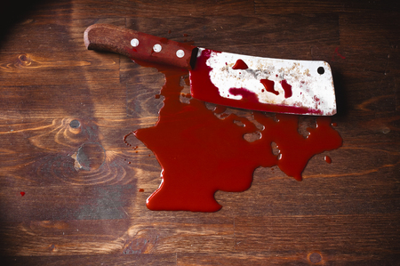 A puddle of blood and rusty knife. Murder.の写真素材