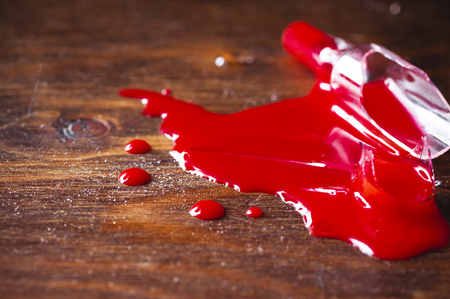Broken vial with a bright red medicineの写真素材