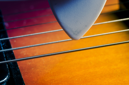 Guitar pick in hand guitar, about electric guitar strings, macro