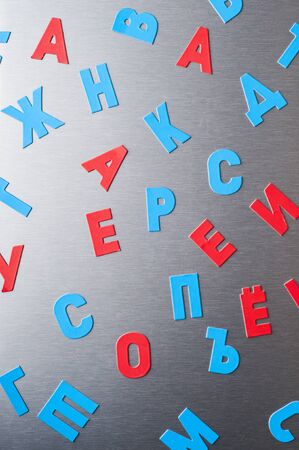 Background with letters of the Russian alphabet on a metal surfaceの写真素材