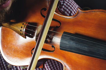 Violin in the hands of the musician. Violinist plays music.の写真素材