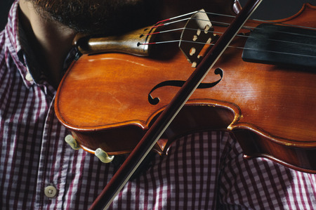 Violin in the hands of the musician. Violinist plays music.の写真素材