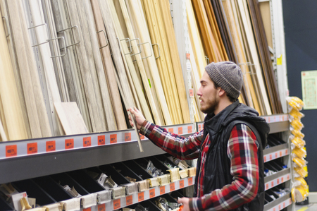 EKATERINBURG, RUSSIA - JANUARY, 8, 2018: A young man chooses baseboard in the hardware storeのeditorial素材