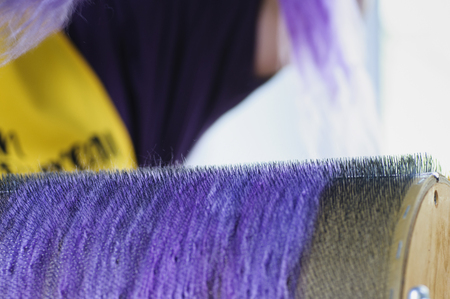 Felting wool. The step of combing the material in a special carding machine.の写真素材